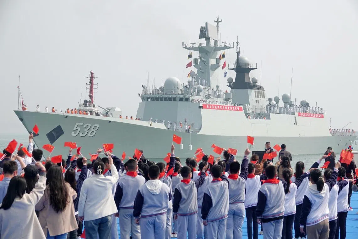 A file photo of people welcoming the Chinese frigate Yantai at Yantai Port in Yantai, China, on April 19.