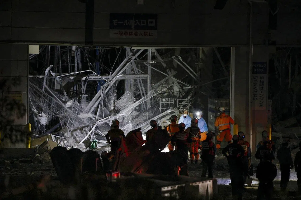 Japan quake toll rises to 13 as rescuers haul people from collapsed mall