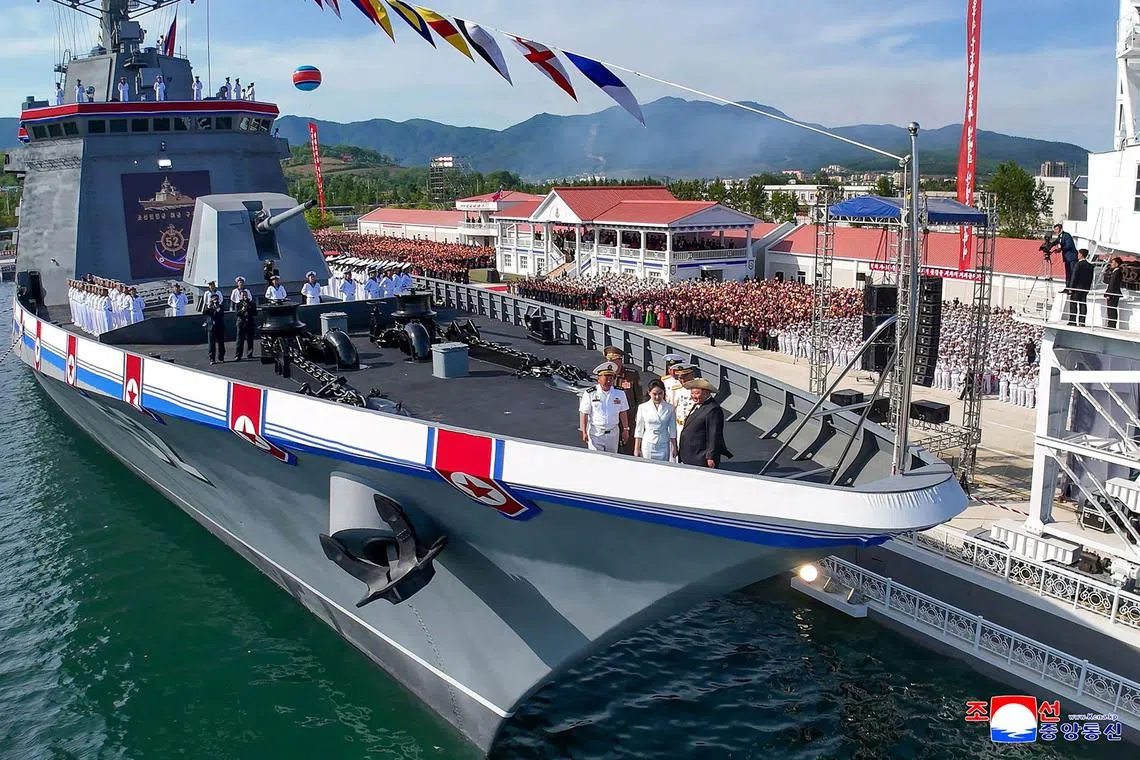 North Korea's leader Kim Jong Un and his daughter Ju Ae attending the launch ceremony for the destroyer Kang Kon at the Rajin shipyard at the port near Rason on June 12, 2025