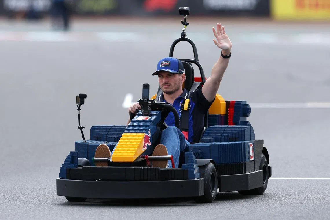 Formula One F1 - British Grand Prix - Silverstone Circuit, Silverstone, Britain - July 5, 2026 Red Bull's Max Verstappen in a car made of Lego blocks ahead of the race REUTERS/Andrew Boyers