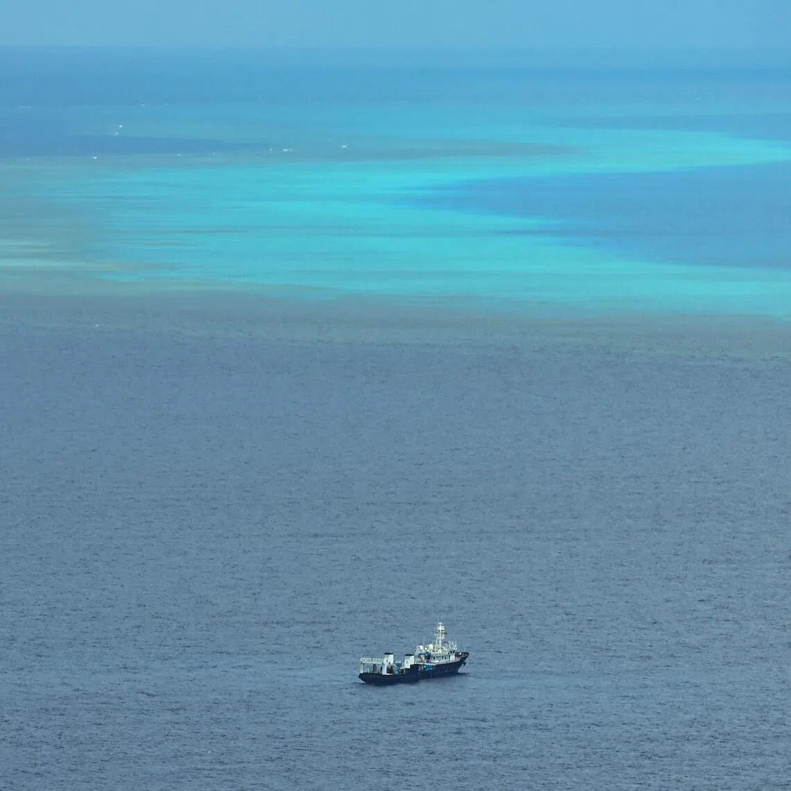 A ship identified by the Philippine Coast Guard as Chinese maritime militia is seen near Scarborough Shoal in the disputed South China Sea on June 15, 2026. (Photo by Jam STA ROSA / AFP)