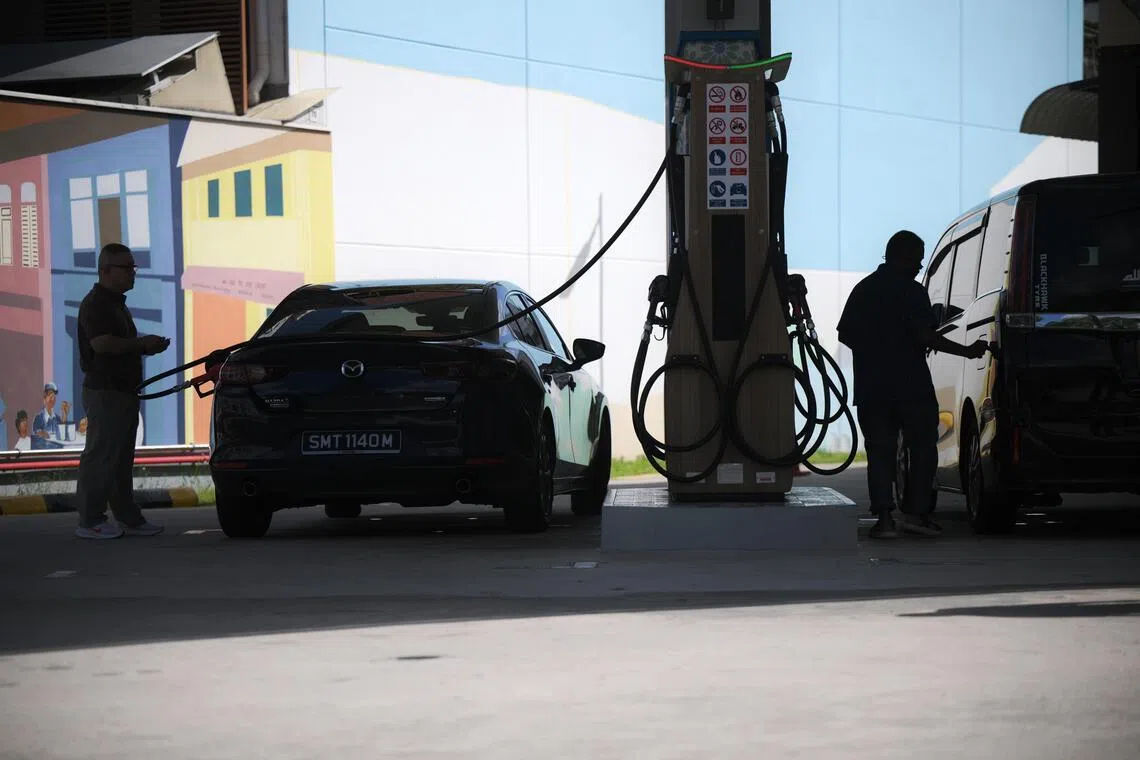 A man pumps his car with petrol at Cnergy petrol station along Dunman Road on March 17, 2026.