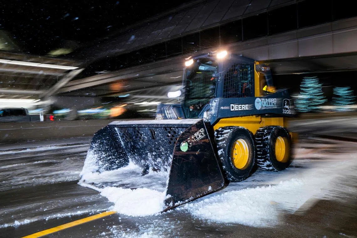 A plow removes snow outside Minneapolis-Saint Paul International Airport on Nov 26, 2025 in Minneapolis, Minnesota.