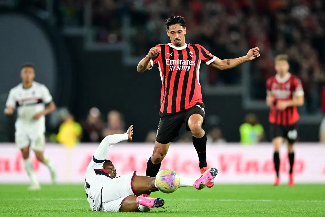 FILE PHOTO: Soccer Football - Coppa Italia - Final - AC Milan v Bologna - Stadio Olimpico, Rome, Italy - May 14, 2025 AC Milan's Tijjani Reijnders in action with Bologna's Jhon Lucumi REUTERS/Daniele Mascolo/File Photo