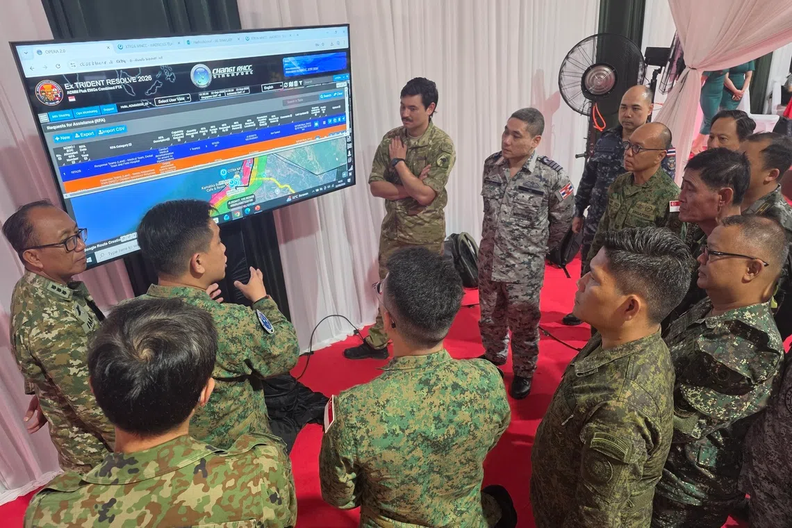 Multinational personnel assessing the situation using the Common Operating Picture on the OPERA Computer Information System at the Multinational Coordination Centre.