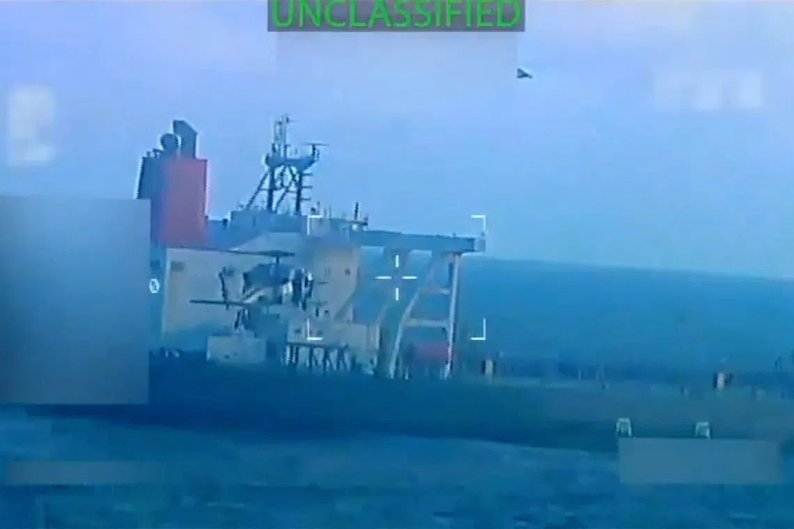 A U.S. military helicopter flies near an oil tanker during a raid described by U.S. Attorney General Pam Bondi as its seizure by the United States off the coast of Venezuela, December 10, 2025, in a still image from video.  U.S. Attorney General/Handout via REUTERS