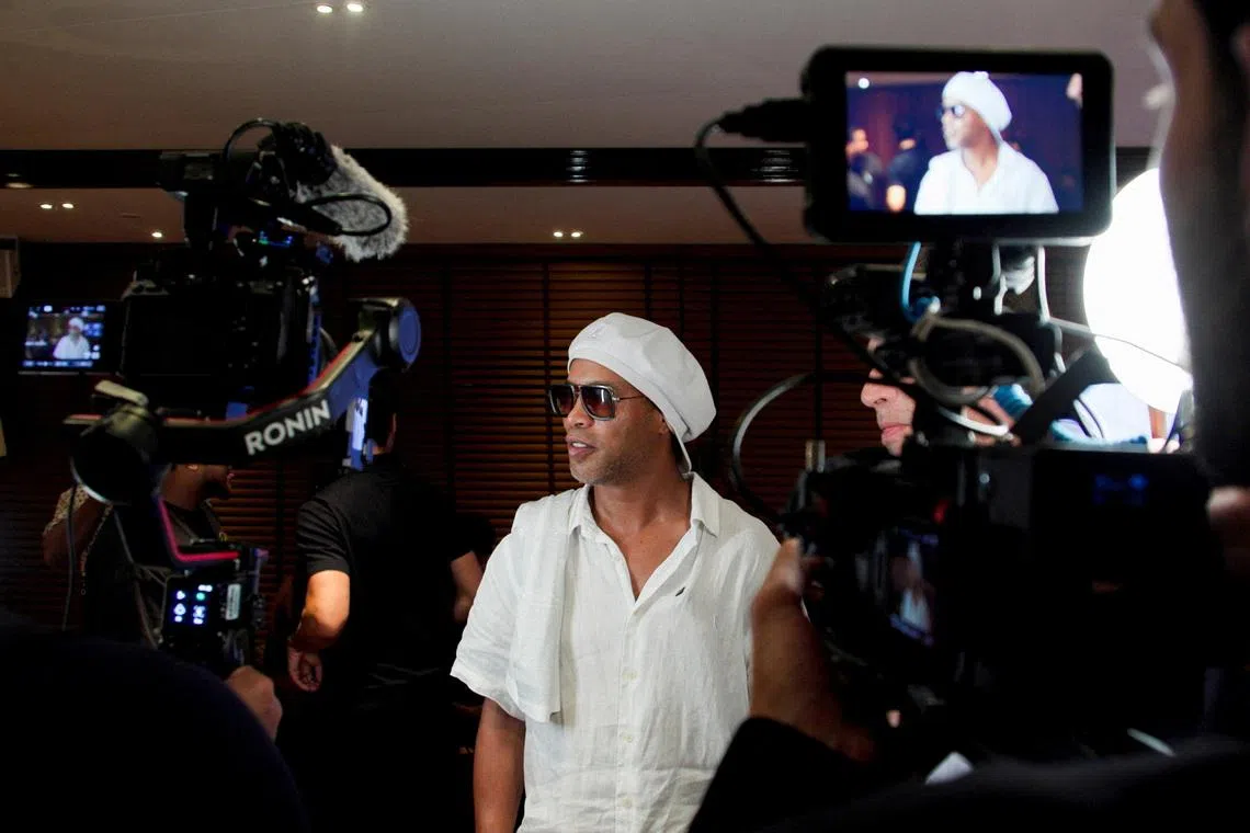 Former Brazil soccer player Ronaldinho speaks in front of cameras after the announcement of his signing with the Italian club Ravenna FC, in Miami, Florida, U.S., June 23, 2026. REUTERS/Maria Alejandra Cardona
