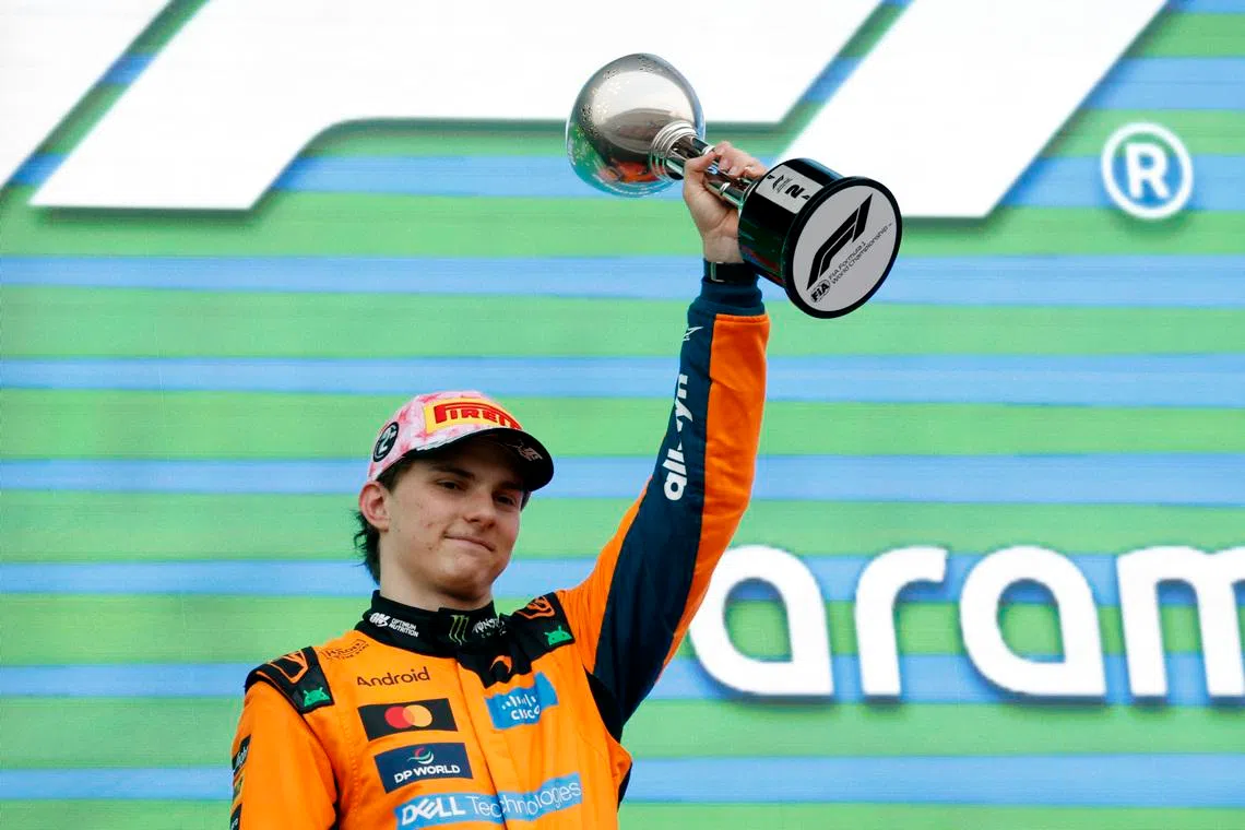 Formula One F1 - Japanese Grand Prix - Suzuka Circuit, Suzuka, Japan - March 29, 2026 McLaren's Oscar Piastri celebrates his second place on the podium with a trophy after the Japanese Grand Prix. REUTERS/Kim Kyung-Hoon