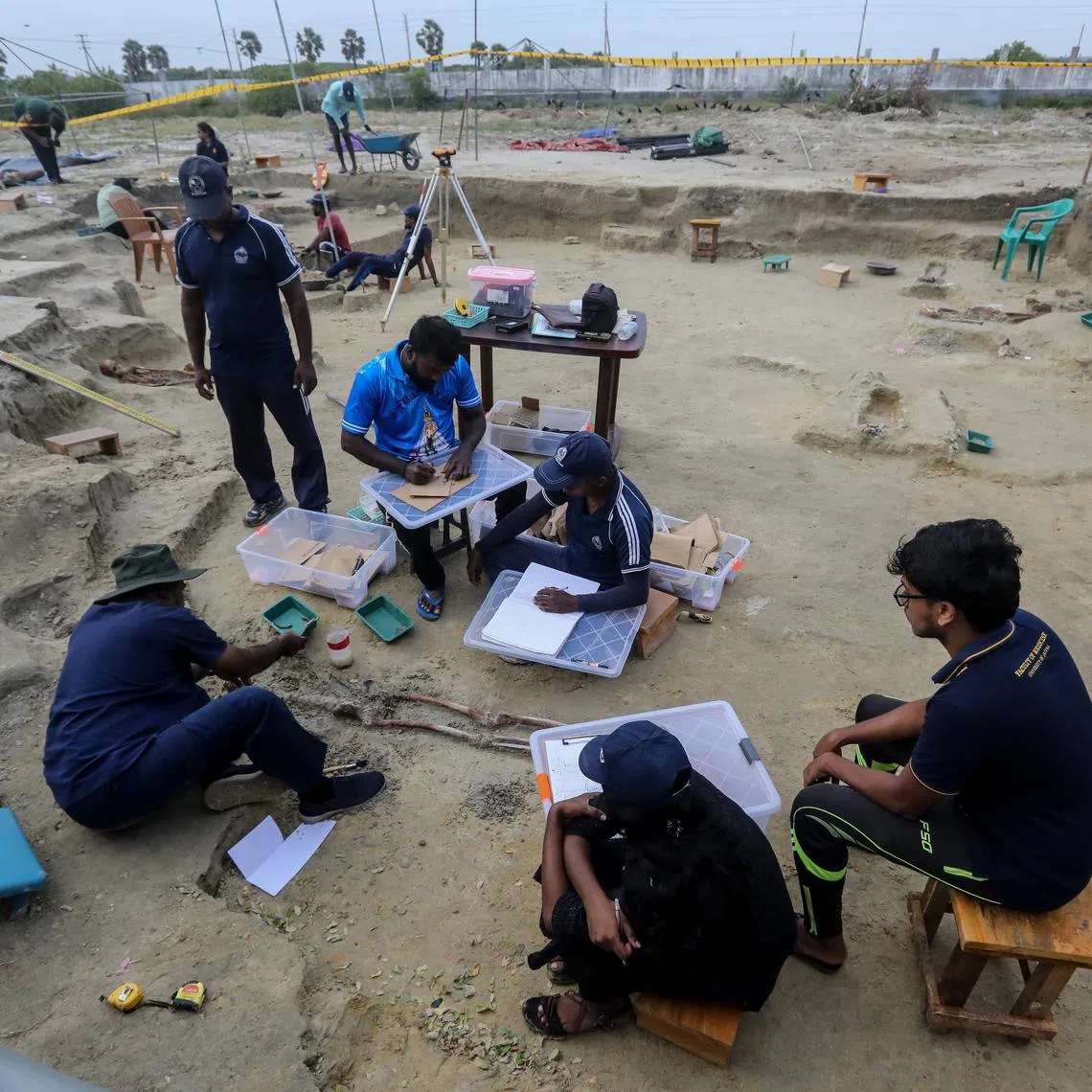 Sri Lankan forensic experts and police officers work at the Chemmani mass grave in the former war zone in Jaffna, Sri Lanka, on July 26.