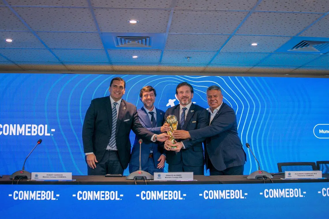 From left: Paraguay's football association president Robert Harrison, Uruguay's football association president Ignacio Alonso, Conmebol president Alejandro Dominguez, and Conmebol vice-president Claudio Tapia poses for a photo with the World Cup trophy in Luque, Paraguay.