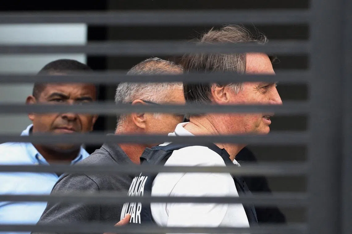 Former Brazilian President Jair Bolsonaro arrives home to begin serving house arrest following authorization by Supreme Court Justice Alexandre de Moraes, after Bolsonaro was convicted by a Supreme Court majority of plotting a coup to remain in power after losing the 2022 election, in Brasilia, Brazil March 27, 2026. REUTERS/Adriano Machado