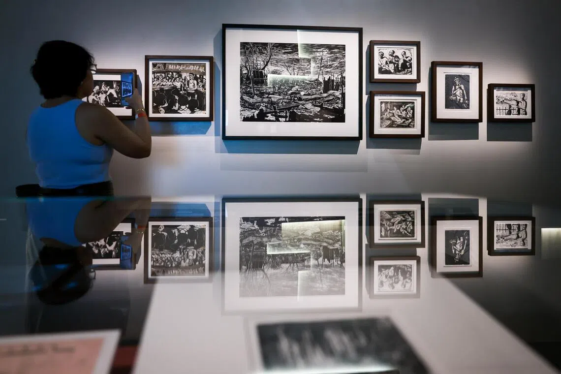 A display of woodcut prints, including Lim Yew Kuan’s After Fire (centre), in the revamped Singapore History Gallery at the National Museum of Singapore.