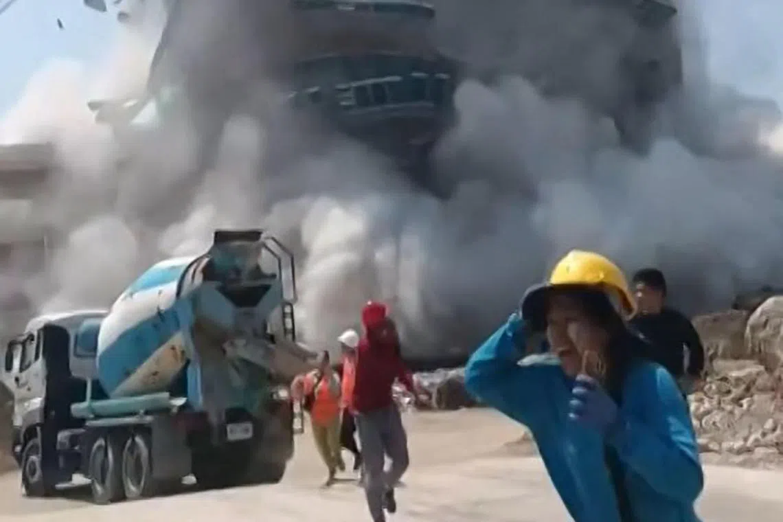 A screen grab from a video taken on March 28 showing workers running away from a building as it collapsed at a construction site in Bangkok.