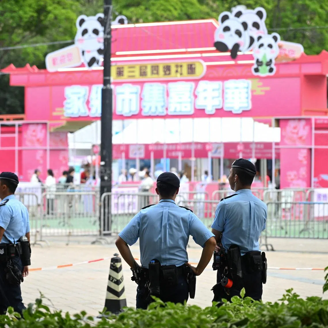 Police patrol outside the entrance of a fair at Victoria Park in Hong Kong's on June 3, 2025, where people traditionally gathered annually on June 4 to mourn the victims of China's Tiananmen Square crackdown.