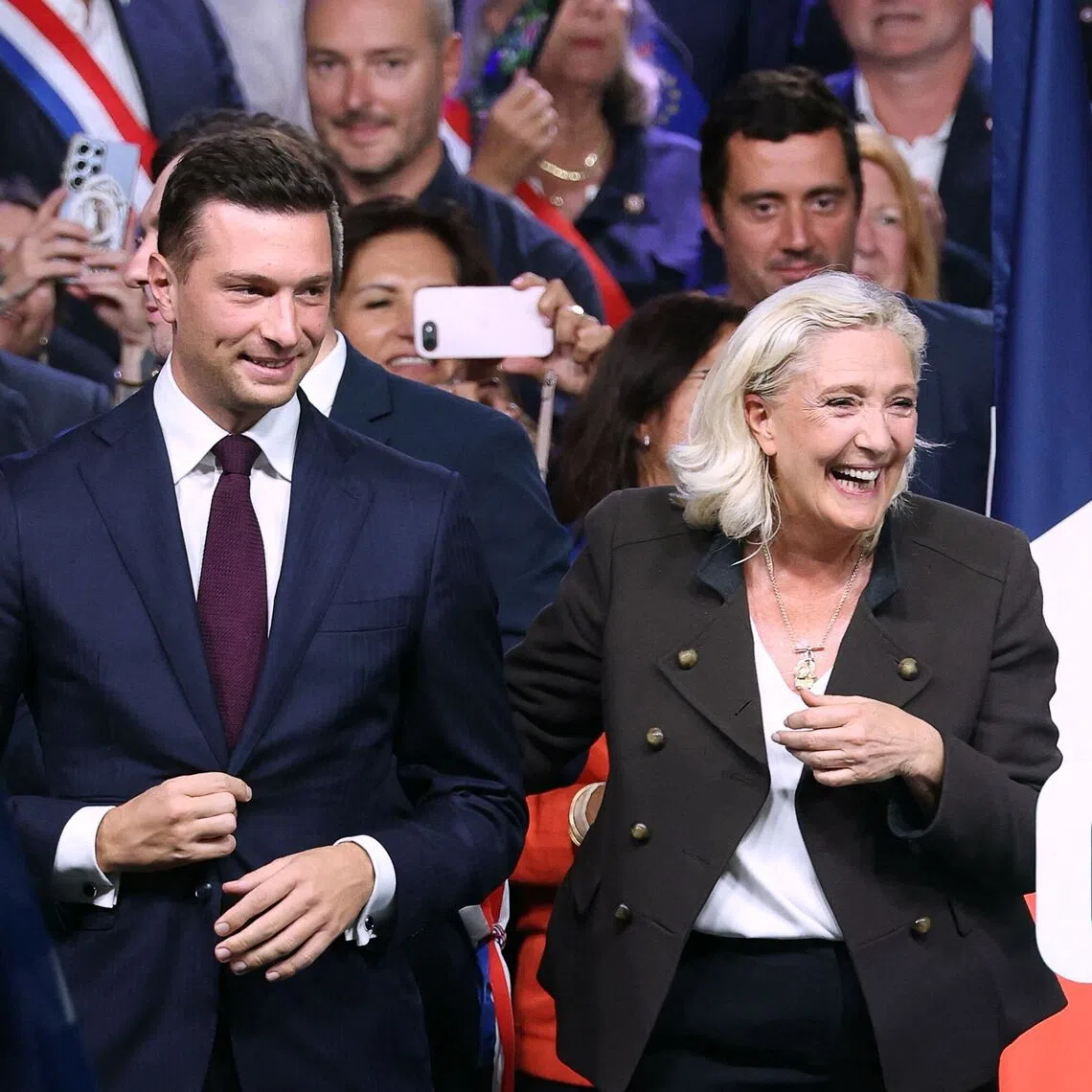 Far-right leader and frontrunner in the French presidency race, Marine Le Pen (right), and Rassemblement National (RN) party president, Jordan Bardella (left), react on stage at the end of a rally in Henin-Beaumont, northern France, on Sept 13, 2026.