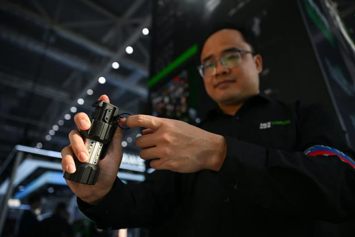 A man demonstrating the use of the Nextorch’s ND30B tactical distraction device at the Public Security Tech Expo in Lianyungang, Jiangsu on Sept 10.