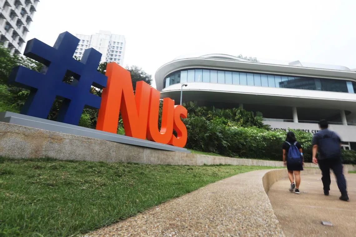 Signage of National University of Singapore (NUS).