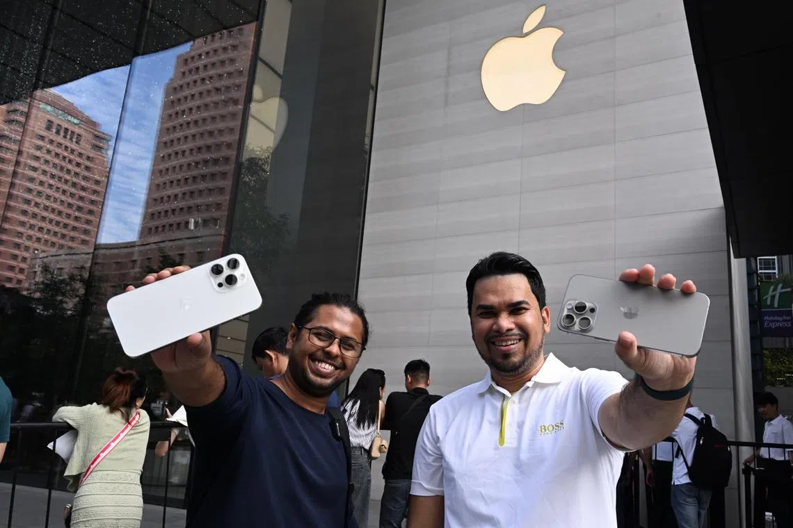 Mr Zaman (left) and Mr Zahid Haque, tech reviewers from Bangladesh, were the first to collect their iPhone at a nearby reseller shop iStudio in Paragon. 

The pair who run a YouTube channel PC Builder Bangladesh arrived in Singapore three days ago.  They were at Orchard Road since 2pm yesterday to join the queue at the Apple Store. 

“Then at 2am this morning, we were walking for a bit and realised that there was no queue at iStudio,” said Mr Zaman who then quickly left to be the first in line at iStudio. 

The pair purchased their phones at 8am. 

ST PHOTO: AZMI ATHNI
