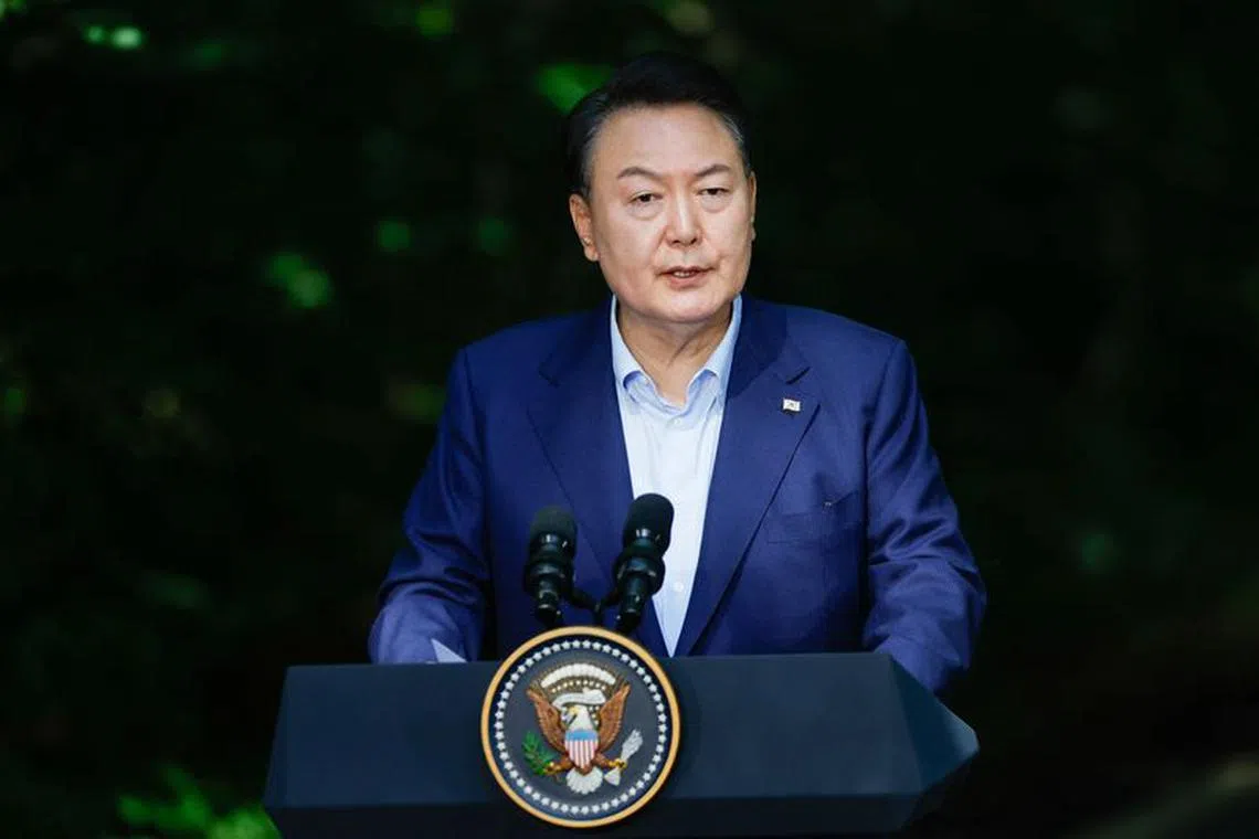 South Korean President Yoon Suk Yeol speaks next to Japanese Prime Minister Fumio Kishida and U.S. President Joe Biden as they hold a joint press conference during the trilateral summit at Camp David near Thurmont, Maryland, U.S., August 18, 2023. REUTERS/Evelyn Hockstein/File Photo