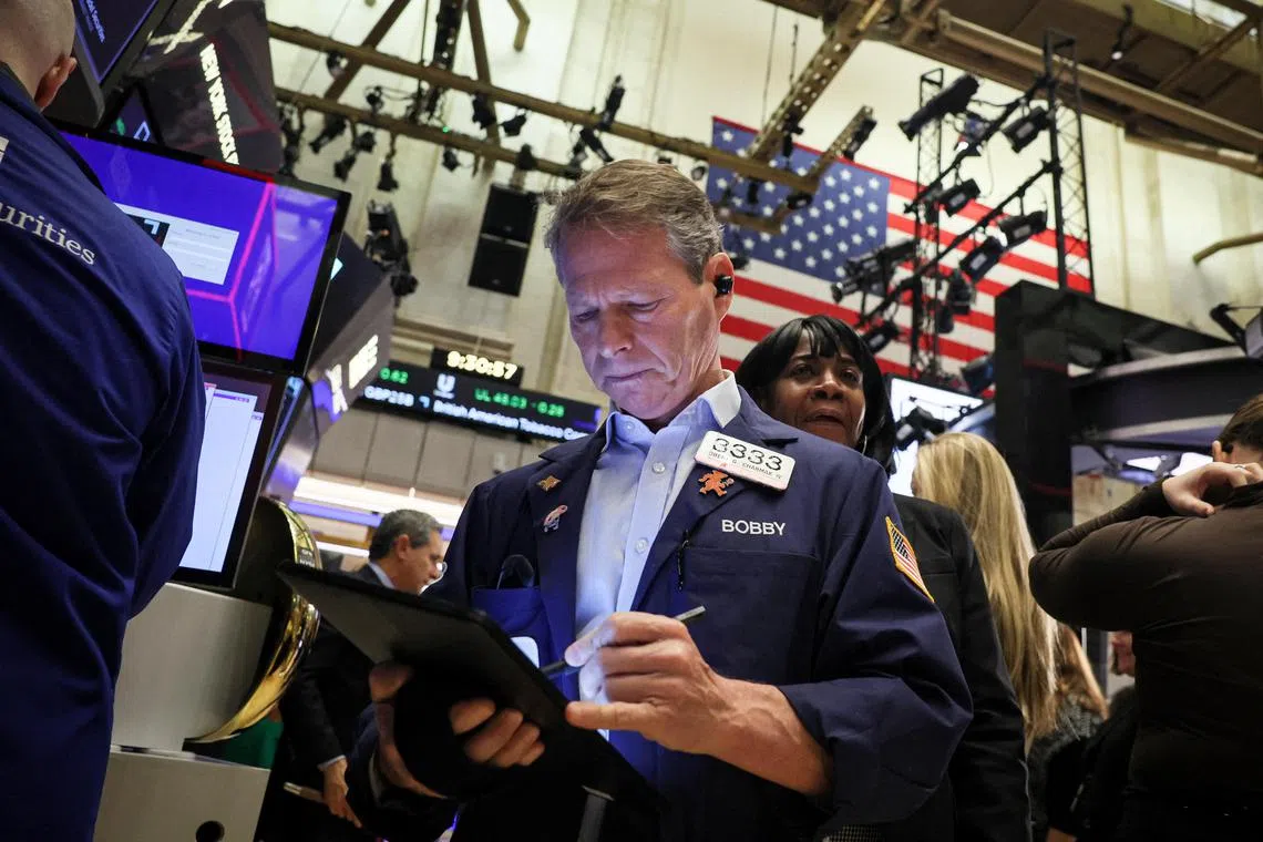 Traders work on the floor at the New York Stock Exchange, in New York City.