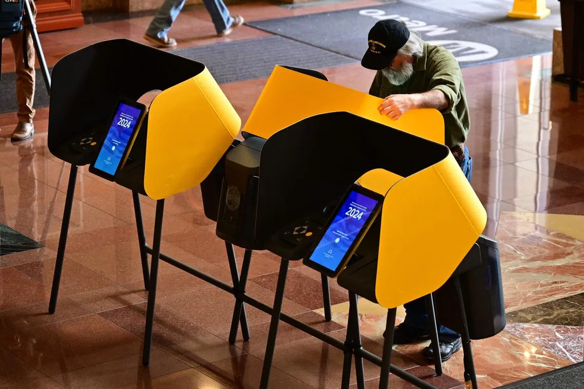 A man casts his ballot during early voting at a polling location at Union Station in Los Angeles, California, on March 4, 2024 ahead of the California Primary election on Super Tuesday, March 5. Americans from 15 states and one territory vote on "Super Tuesday," a campaign calendar milestone expected to leave former US President and 2024 presidential hopeful Donald Trump a hair's breadth from securing the Republican Party's presidential nomination. (Photo by Frederic J. BROWN / AFP)