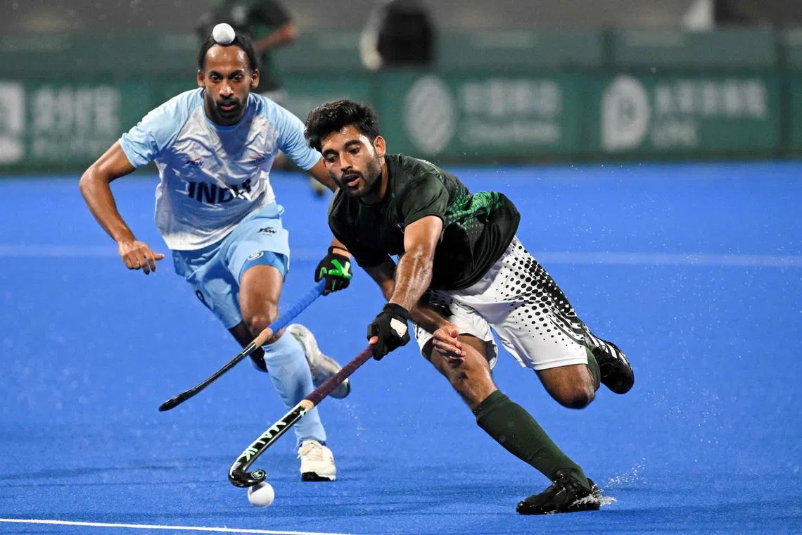 Pakistan's Abdul Waheed Ashraf Rana (right) controlling the ball as India's Hardik Singh looks on during the preliminary men's pool hockey match between India and Pakistan at the 2022 Asian Games in Hangzhou in China's eastern Zhejiang province on Sept 30, 2023. Pakistan will not travel to India for upcoming hockey tournaments over "security" concerns, government sources told AFP on July 12, 2025, potentially jeopardising their place in the 2026 World Cup. 