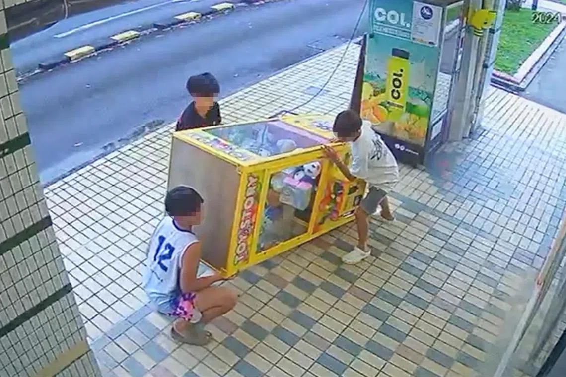 The trio appear to almost lay the machine sideways on the ground before standing it upright again.