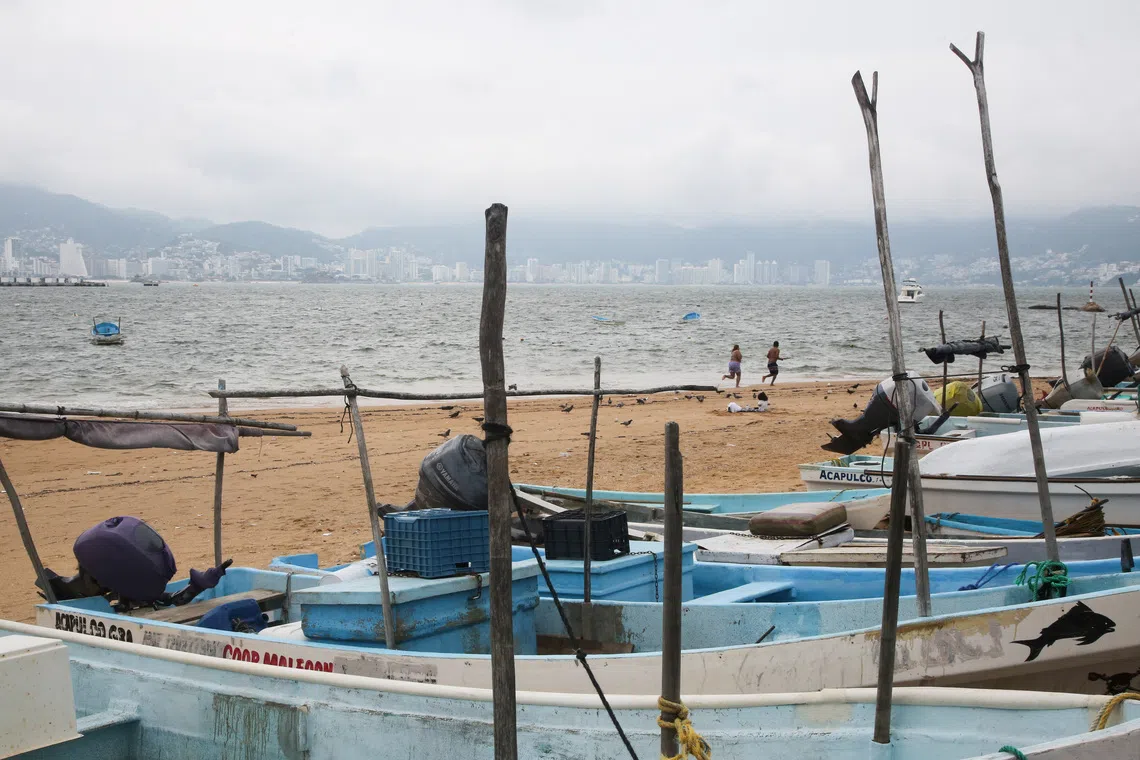 Fishing boats rest on the sand after being pulled from the sea as Hurricane Trudy moves parallel to Mexico's Pacific coast, threatening more rain and strong winds after recent deadly storms, in Acapulco, Mexico, October 15, 2026. REUTERS/Javier Verdin