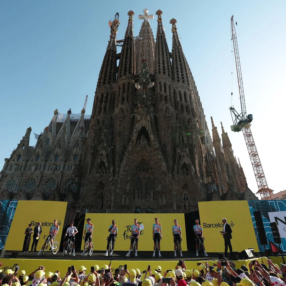 Cycling - Tour de France - Previews - Hospital Sant Pau, Barcelona, Spain - July 2, 2026  NSN Cycling Team's Jake Stewart, Biniam Girmay Hailu, Lewis Askey, Matis Louvel, Tom Van Asbroeck, Marco Frigo, George Bennett and Krists Neilands during the presentation as the Basilica of the Sagrada Familia is seen REUTERS/Gonzalo Fuentes