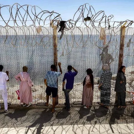 Relatives and friends waiting by a fence in Morocco for the return of people who had crossed into Spain’s North African exclave of Ceuta.