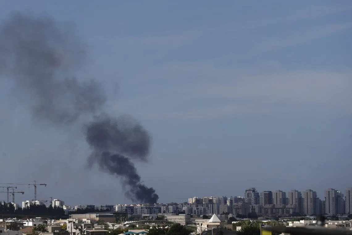 Smoke rising over the Israeli city of Ashkelon following rocket launches from Gaza, on Oct 7.