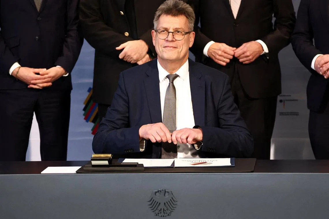 Olympic Sports Confederation (DOSB) President Thomas Weikert signs an agreement on Germany’s Olympic bid with German Chancellor Friedrich Merz and the heads of government from participating states and cities, in Berlin, Germany, December 4, 2025. REUTERS/Liesa Johannssen/File Photo
