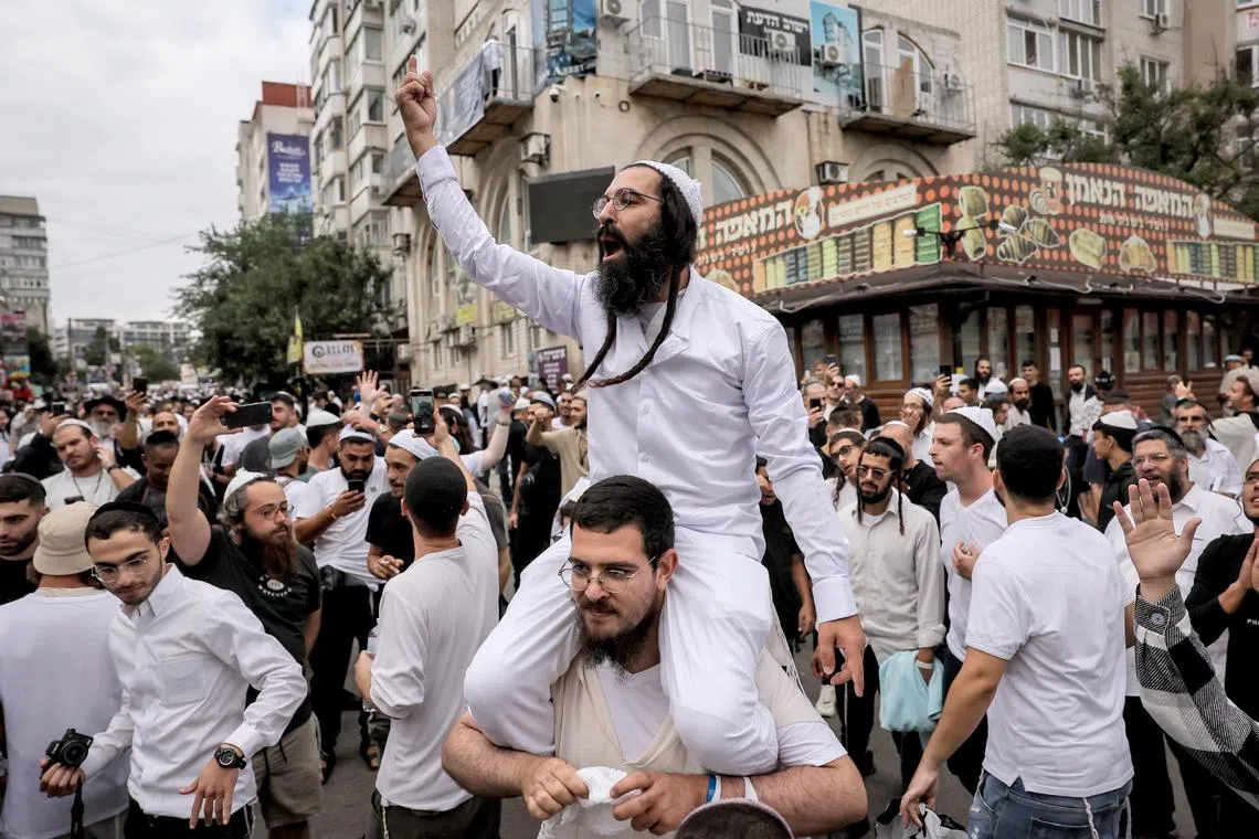 Ultra-Orthodox Jewish pilgrims dance near the tomb of Rabbi Nachman, ahead of Rosh Hashanah, in Uman, central Ukraine.