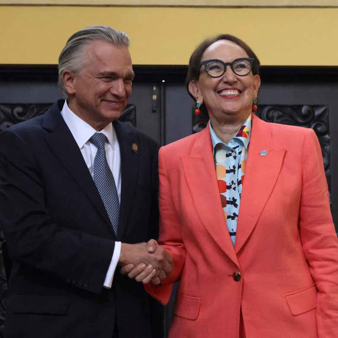 Rebeca Grynspan, former Vice President of Costa Rica, and Costa Rica's Foreign Affairs Minister Arnoldo Andre Tinoco shake hands after a news conference where the government announced her nomination for United Nations secretary-general, in San Jose, Costa Rica, October 8, 2025. REUTERS/Mayela Lopez