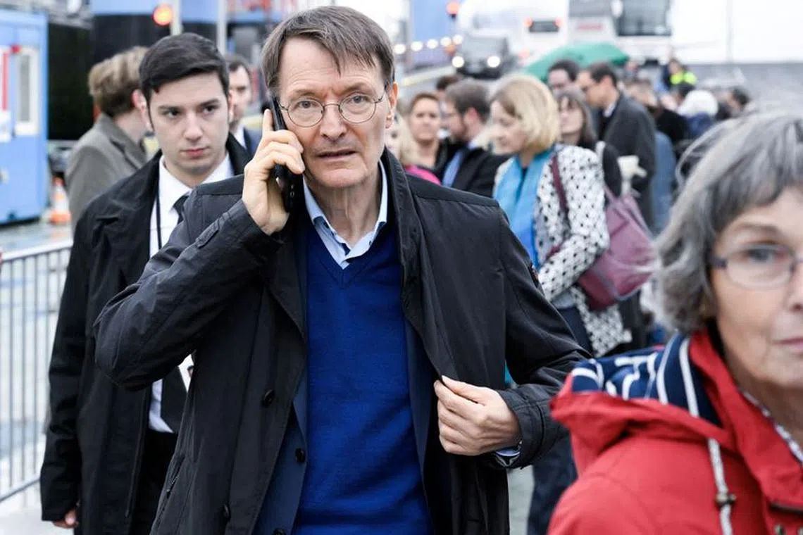 FILE PHOTO: German Health Minister Karl Lauterbach makes a phone call as he arrives for a boat tour through the Port of Hamburg, during a two-day meeting of the German and French governments in Hamburg, Germany, October 9, 2023.  John Macdougall/Pool via REUTERS/File Photo