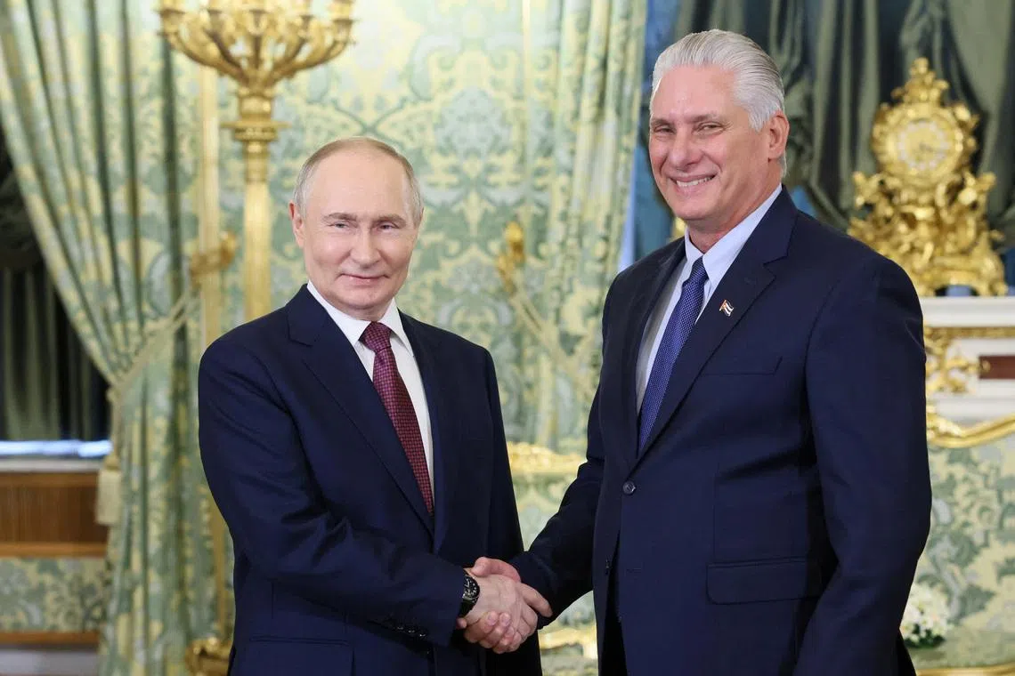 Russian President Vladimir Putin shakes hands with Cuban President Miguel Diaz-Canel during a meeting at the Kremlin in Moscow, Russia, May 7, 2025. Sputnik/Mikhail Metzel/Pool via REUTERS