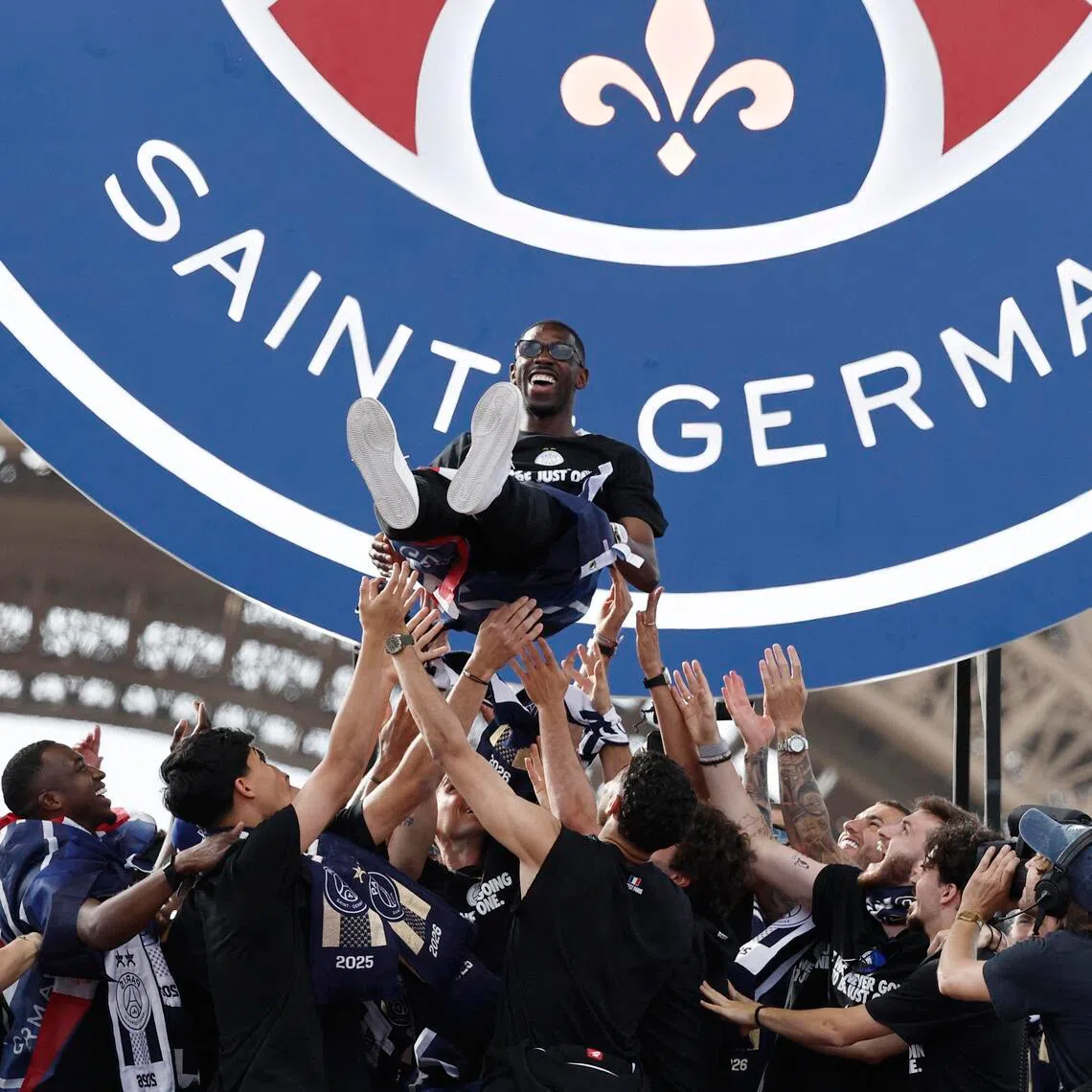 Paris Saint-Germain players lifting Ousmane Dembele in the air on May 31, as they celebrate winning the UEFA Champions League.
