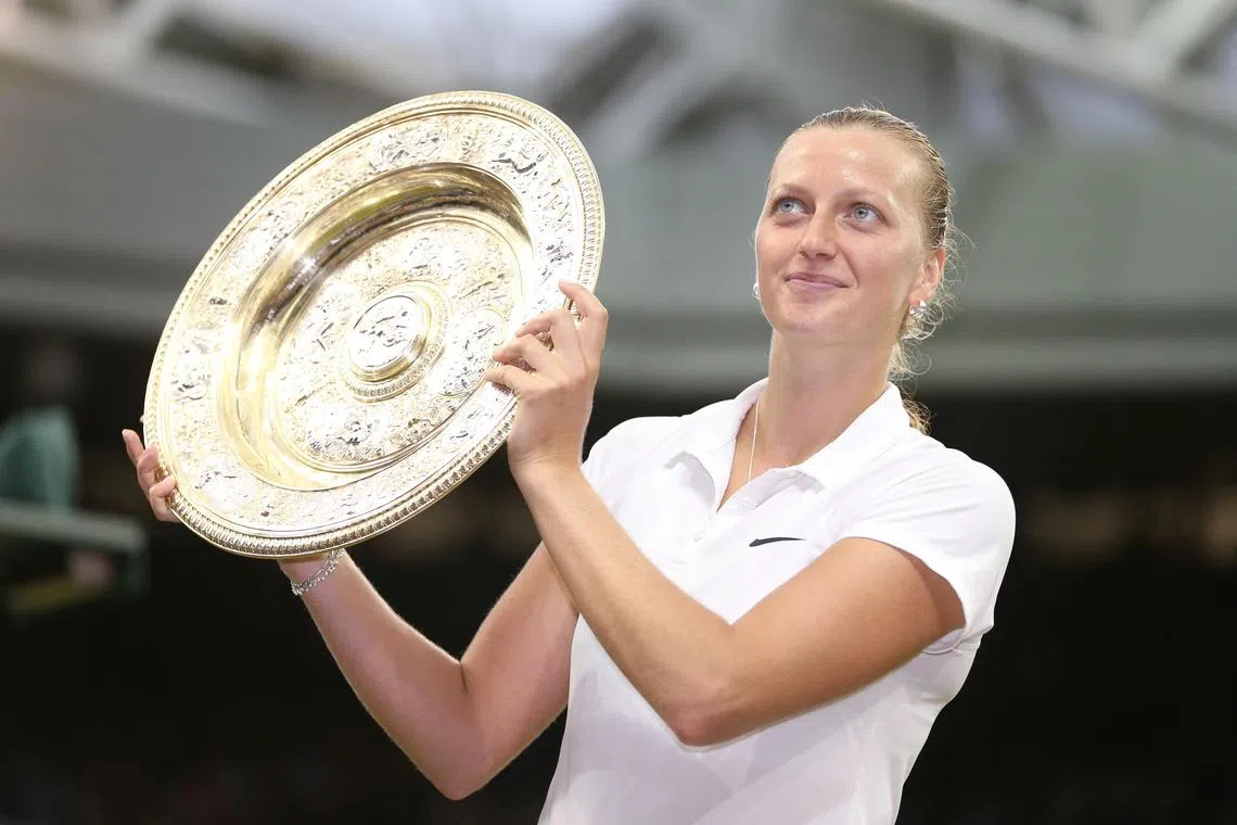 FILE PHOTO: Tennis - Wimbledon - All England Lawn Tennis & Croquet Club, Wimbledon, England - 5/7/14   Women's singles - Czech Republic's Petra Kvitova celebrates with the trophy after winning the final   Action Images / Henry Browne/File Photo
