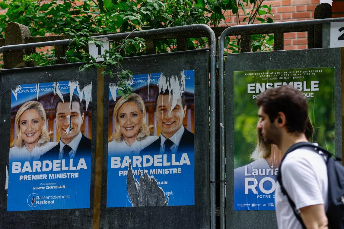 Election posters in Paris featuring the far right National Rally's Ms Marine Le Pen (left) and Mr Jordan Bardella.