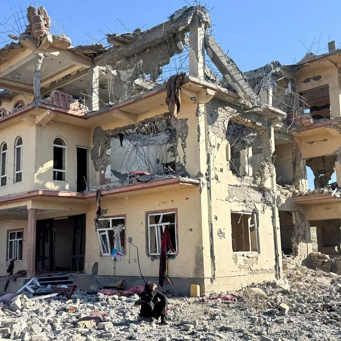 A man sits in front of a destroyed building after an attack, which the Taliban say was an airstrike carried out by Pakistan's security forces, in Samkani District, Paktia Province, Afghanistan, June 29, 2026. REUTERS/Stringer
