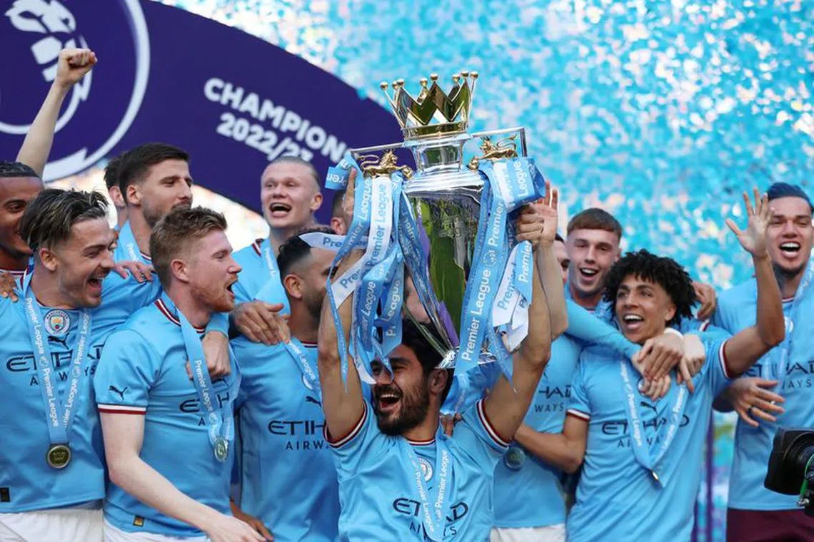 FILE PHOTO: Soccer Football - Premier League - Manchester City v Chelsea - Etihad Stadium, Manchester, Britain - May 21, 2023 Manchester City's Ilkay Gundogan lifts the trophy as he celebrates with teammates after winning the Premier League Action Images via Reuters/Lee Smith/File Photo