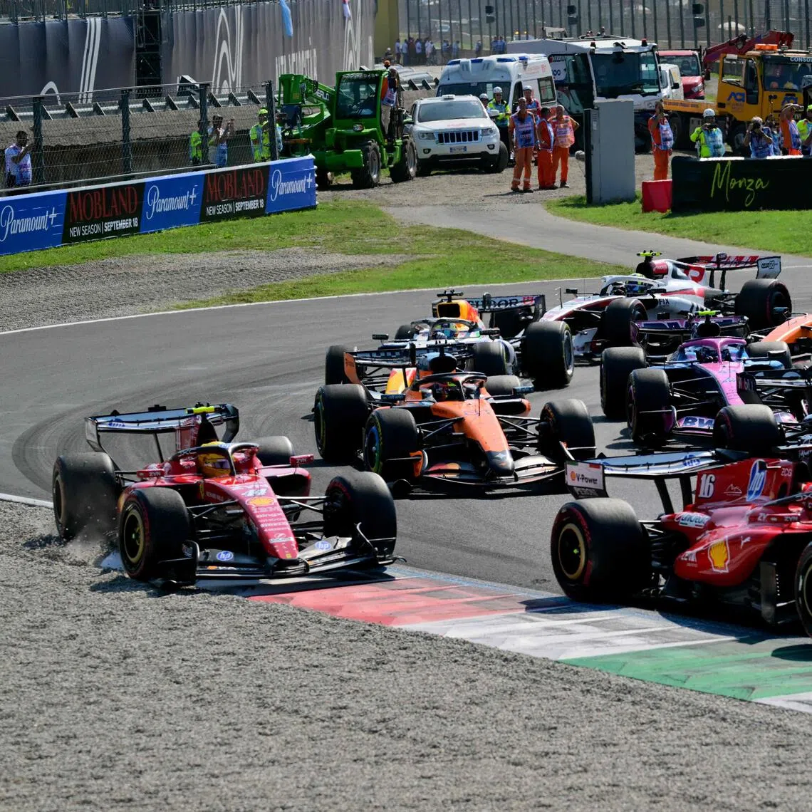 Ferrari’s Lewis Hamilton (left) is pushed off the track by teammate Charles Leclerc (right) at the start of the Sept 6 Italian Grand Prix.
