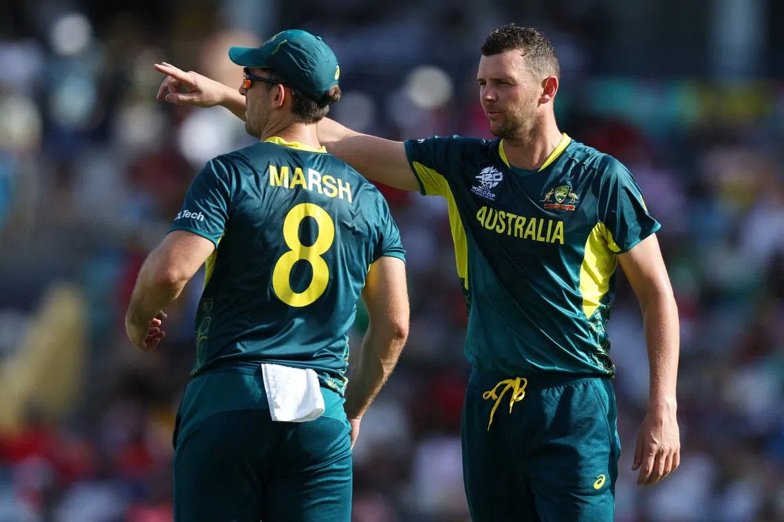 FILE PHOTO: Cricket - ICC T20 World Cup 2024 - Group B - Australia v England - Kensington Oval, Bridgetown, Barbados - June 8, 2024 Australia's Josh Hazlewood and Mitchell Marsh talks during play REUTERS/Ash Allen/File Photo