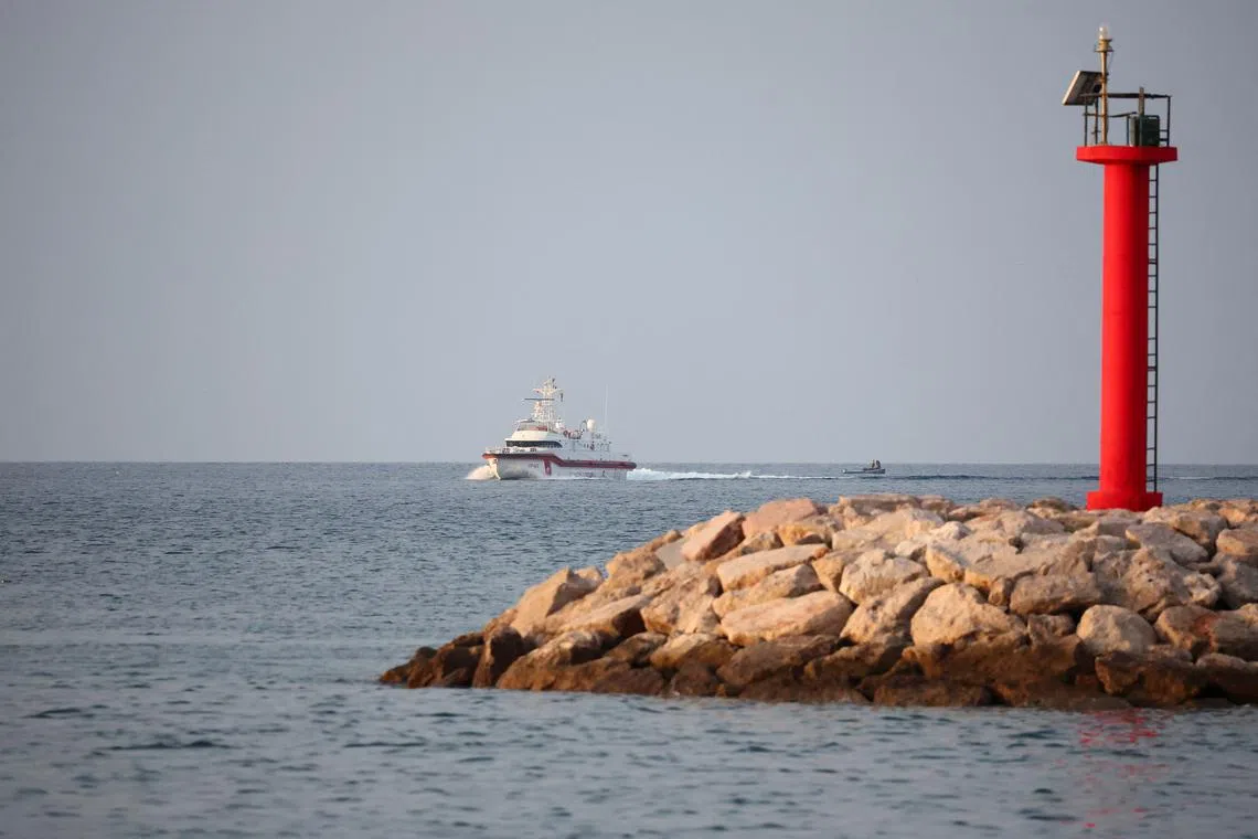 An Italian coast guard vessel arrives to transfer migrants, who were intercepted at sea and later detained at a reception facility in Albania, to Italy after a court in Rome overturned their detention orders, in Shengjin, Albania, October 19, 2024. REUTERS/Florion Goga/File Photo