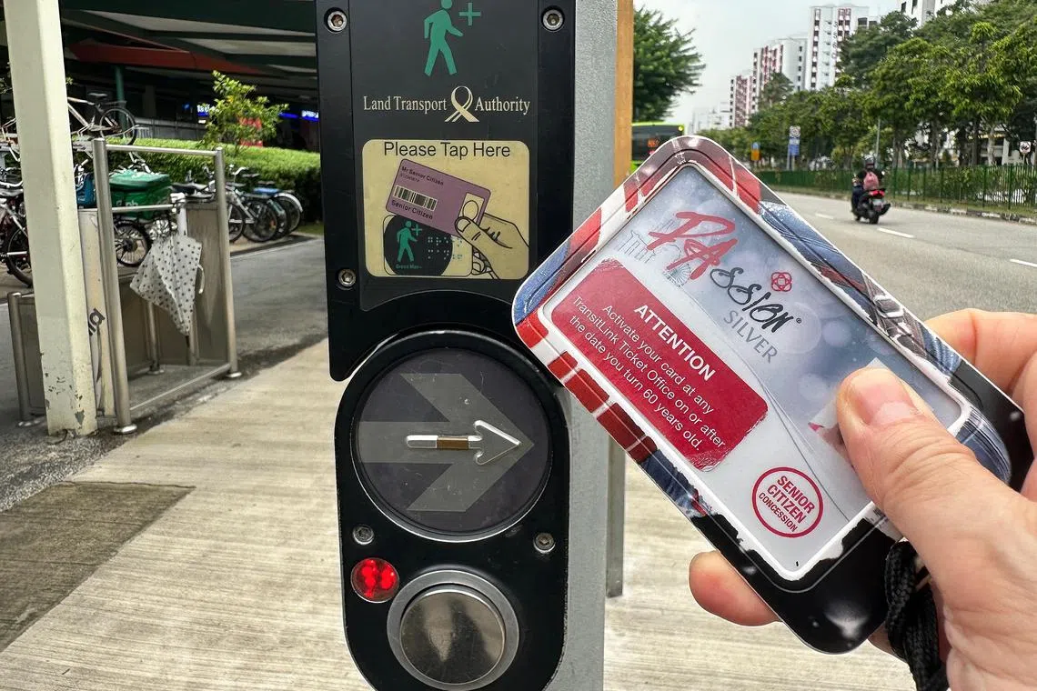 Generic picture of a Passion Silver Card for seniors tapping the signalised pedestrian crossings fitted with Green Man . Picture was taken on 1 November 2023 along Sembawang Way. LTA progressively rolling out 1,500 more pedestrian crossings with #GreenMan (GM ) card readers islandwide. Once completed by Q4 2027, this would bring the total number of GM readers to over 2,500.