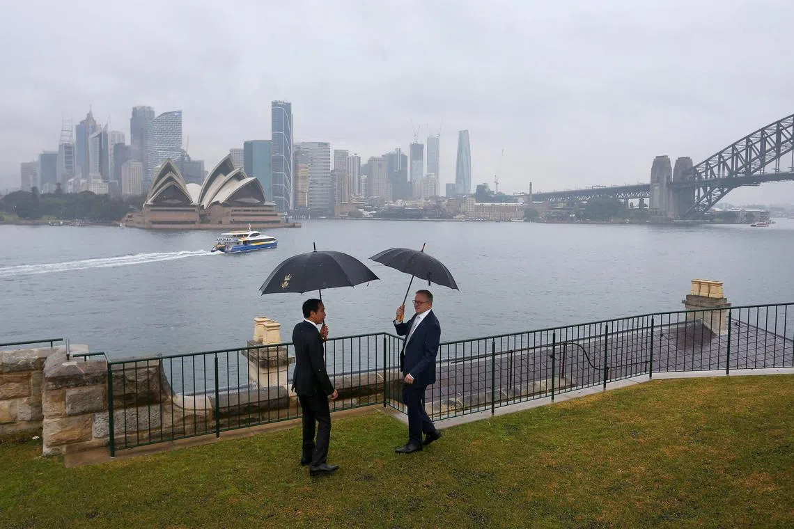 Australian Prime Minister Anthony Albanese (R) speaking with Indonesian President Joko Widodo (L) in front of the Opera House and city skyline, at Admiralty House in Sydney on July 4, 2023. 