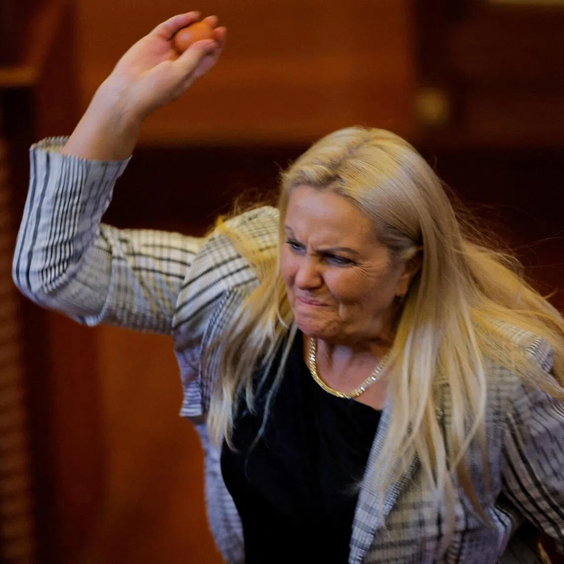 Lawmaker Time Kadriaj throwing an egg at Prime Minister Albin Kurti (not pictured) on Aug 8, during a session to elect a new parliamentary speaker.