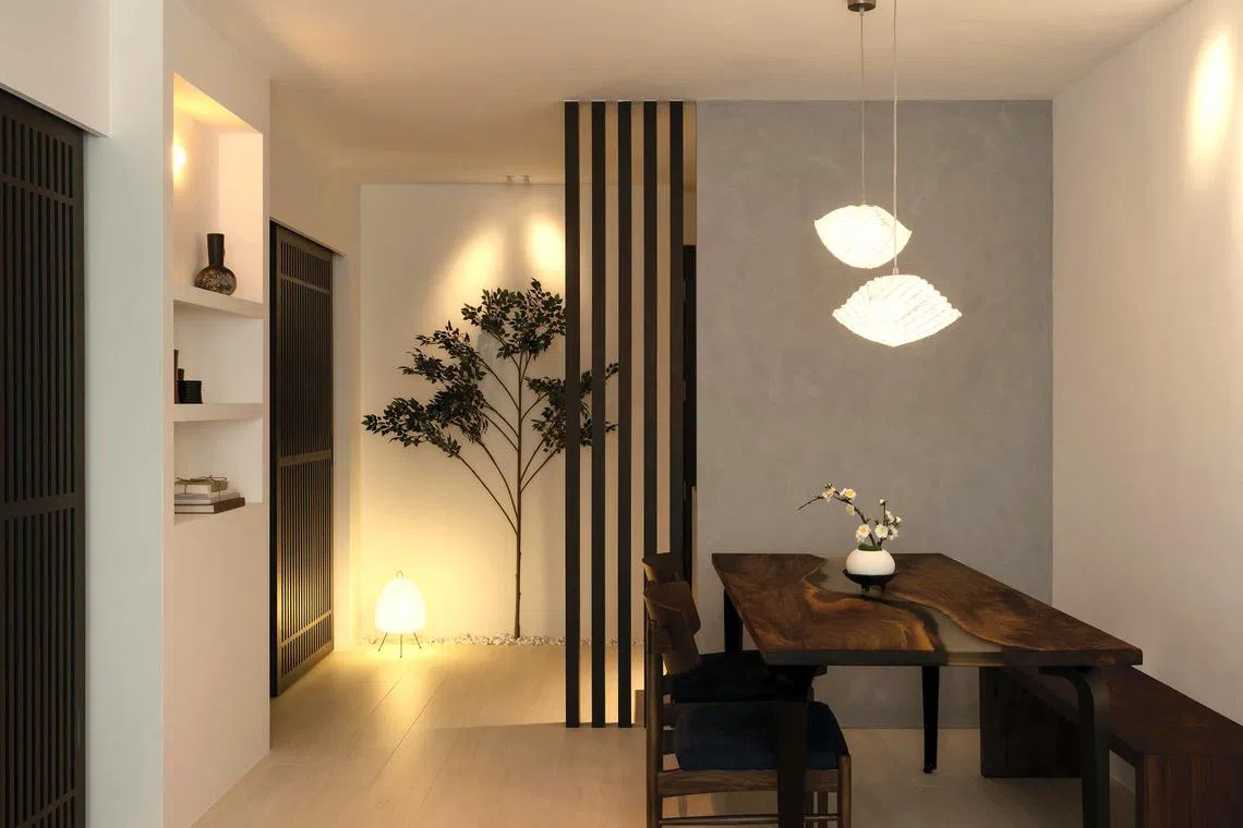 Software engineer Andi wanted a dark Japandi look for his HDB flat, which he shares with a pet cat.