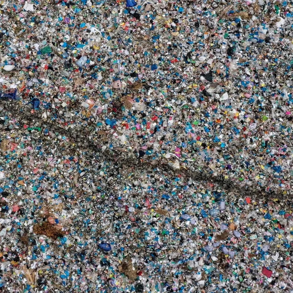 Microplastics come from larger plastics, including manufactured products and industrial materials, which degrade over time into tiny, even microscopic pieces.