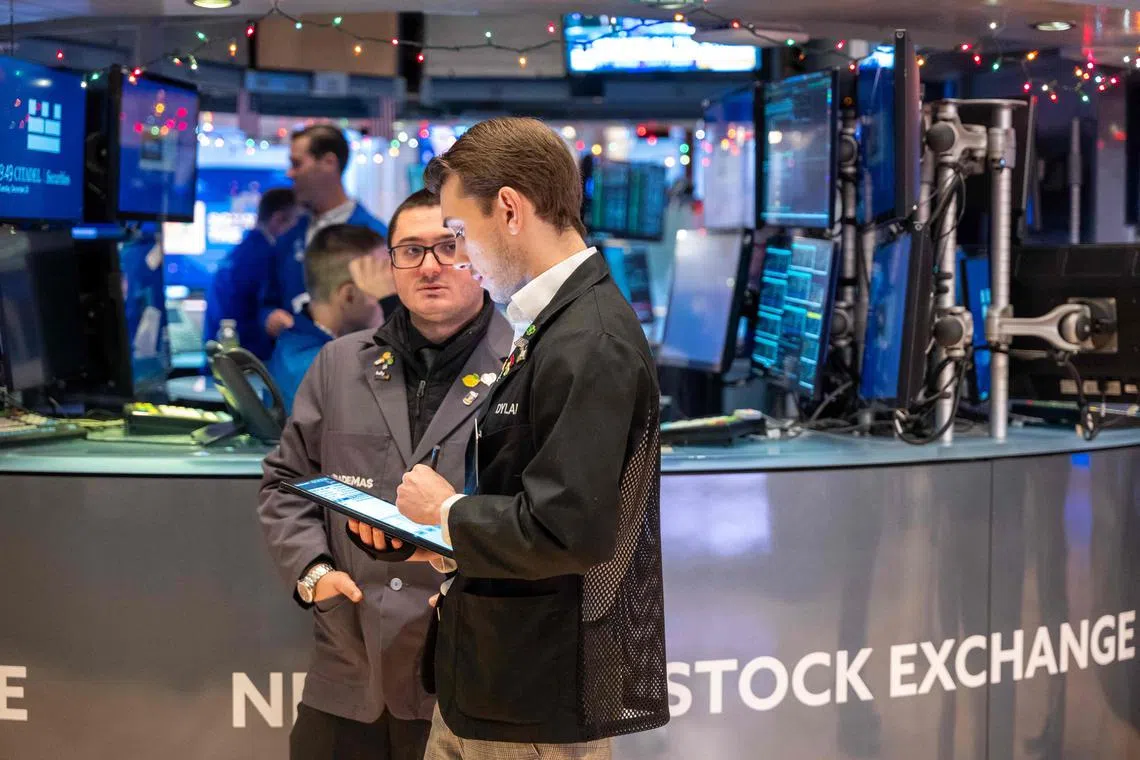 Traders work on the floor of the New York Stock Exchange, in New York City.